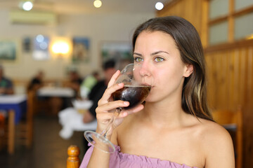 Woman drinking soda in a restaurant