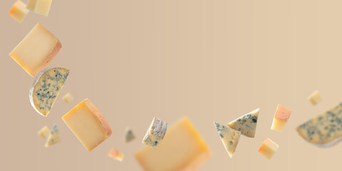 Pieces of various cheese flying in the air. Falling isolated cheese on light beige background with copy space
