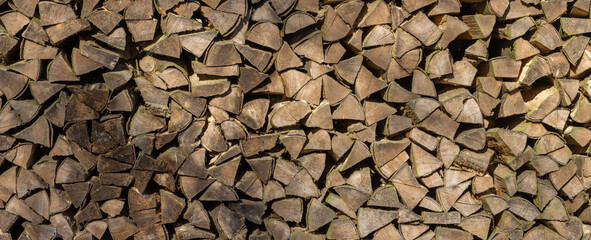 Stack of chopped firewood for wooden background