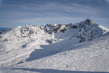 View of the Tatra Mountains in winter from the peak of Kasprowy Wierch. Sunny weather during a hike in the mountains.