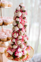 Sweet table. Strawberries in white chocolate. party reception, decorated in restaurant. candy bar.