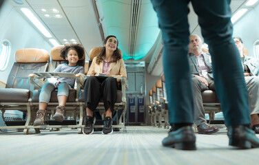 Flight attendants show how to use safety devices and recommend emergency exits.