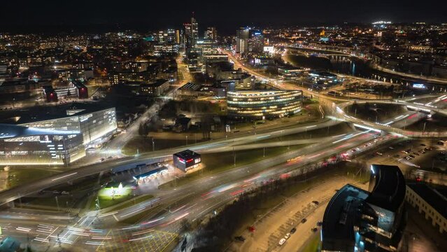 High quality night aerial hyperlapse footage above Lithuania's Capital Vilnius. Slow flying drone camera. Streets, buildings, traffic visible.