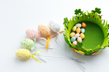 Easter toys. Wooden Easter eggs on white background, copy space.