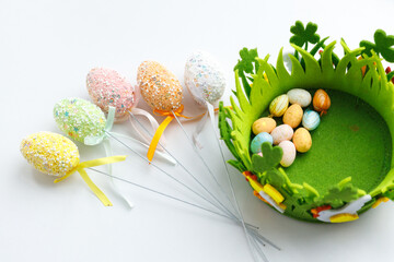 Easter toys. Wooden Easter eggs on white background, copy space.