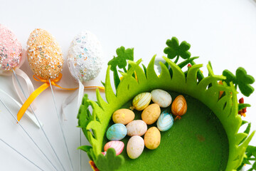 Easter toys. Wooden Easter eggs on white background, copy space.