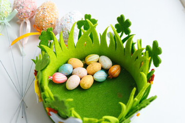 Easter toys. Wooden Easter eggs on white background, copy space.