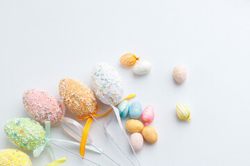 Easter toys. Wooden Easter eggs on white background, copy space.