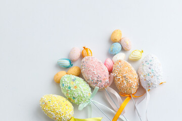 Easter toys. Wooden Easter eggs on white background, copy space.