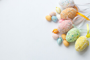 Easter toys. Wooden Easter eggs on white background, copy space.