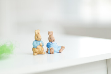 Handmade Easter bunny. Blurred background. Easter toys. Wooden Easter eggs on white background, copy space.