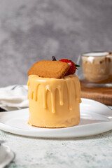 Caramel and biscuit cake. Patisserie products. Liquid caramel cake on a gray background. Close up