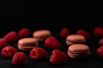 macaroons of different colors on a black background