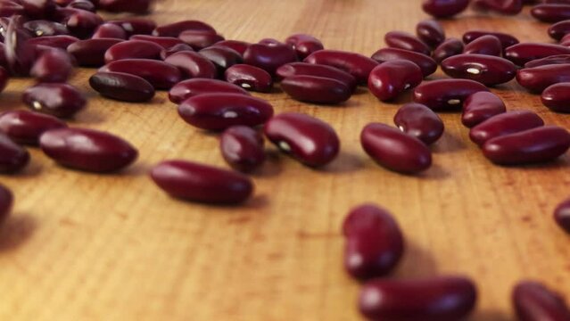 Close-up. Red beans are poured on a wooden board. Preparation of healthy food
