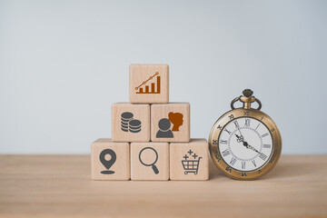 For business research, customer persona concept. Vintage clock and  stack of wooden cube block with business icon