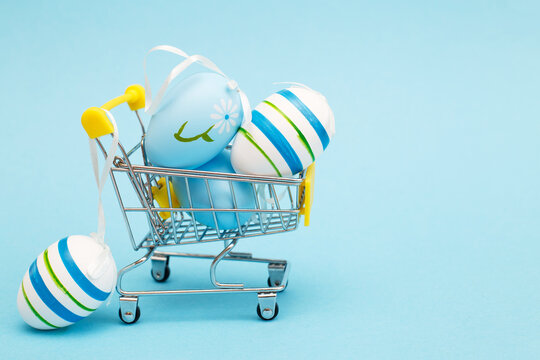Easter eggs in the shopping cart on a blue background