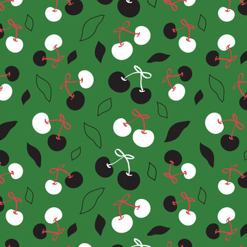 Seamless pattern of Black and White Cherries on green blackground ideal for fabric,print,card,wallpaper,mobile case etc