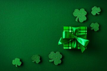 Saint Patrick day concept flat lay with green gift box close up on yellow background,