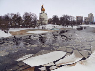 Orthodox church and jordan’ by lake in town in thaw: ice drift, ice floes. © ROMAN BELIAKOV