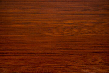 Reddish brown wood grain background.