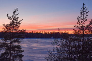 Sunset in winter on Finnish Tuusula lake: view from Halosenniemi.