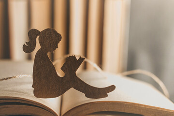 child psychology concept. An introvert girl reads a bedtime story against the backdrop of books
