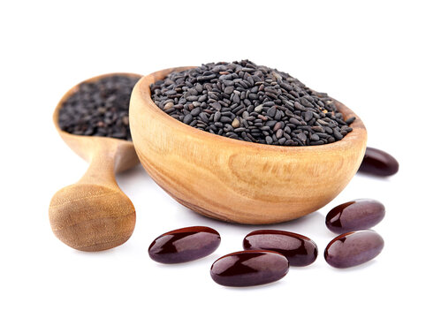 Black cumin oil pill. Oil capsules. Nigella sativa (Blatsk cumin). Nigella or Black cumin over white background.