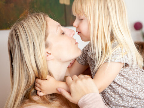 Family Life, A Kiss for Mum. A candid and affectionate moment between a mother and her young daughter. From a series of related images.