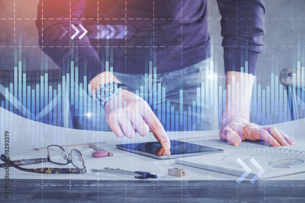 Poster double exposure of man's hands holding and using a digital device and forex graph drawing. financial