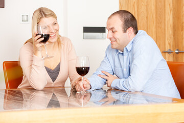 Family Life, Date Night. A married couple reconnecting and enjoying each others company and a glass of wine at home. From a series of related images.
