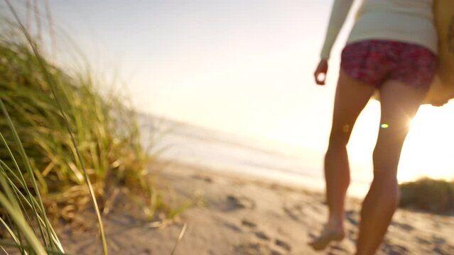 Florida sunrise outdoor girl beach walking with surfboard 