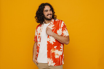 Positive hispanic guy posing isolated over yellow wall