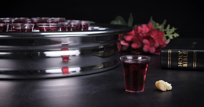 Taking communion concept - the wine and the bread symbols of Jesus Christ blood and body with Holy Bible. Easter Passover and Lord Supper concept. Dolly shot 4k