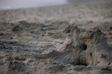 Built House sand castle with towers on the south shore of the sandy beach blue sea 