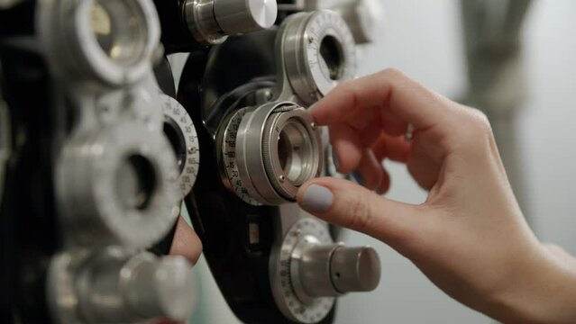Patient getting an eye exam with an optometrist in an eye clinic using a phoropter