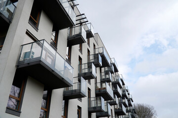 Fototapeta premium Modern residential building with balconies. Real estate and housing issues concept.