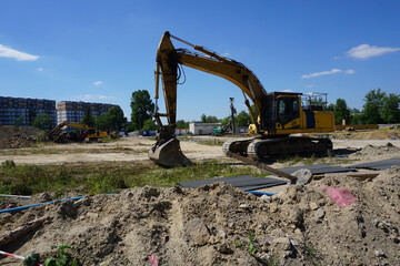 Yellow excavator on construction site