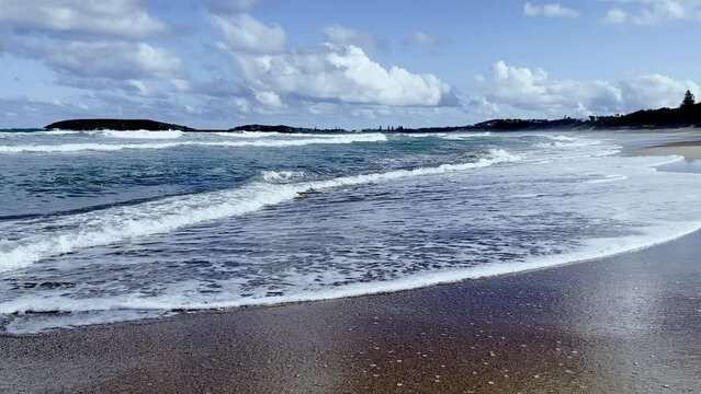 Landscape sea wave washing on sandy beach background.