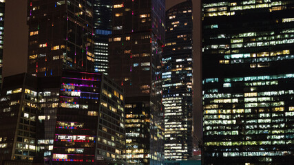 Obraz premium panoramic background with of illuminated skyscrapers in Moscow city business district in night