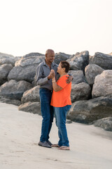 Senior couple dancing at the beach