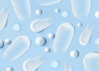 cosmetic smears cream texture on pastel blue background