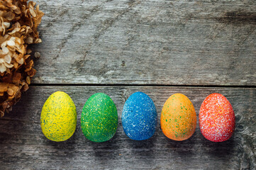 Easter eggs in a nest on a wooden background. High quality photo. nest of dried flowers. place for teekst, banner