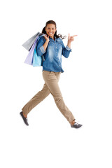 Next stop...the next shop. Studio portrait of an attractive young woman carrying shopping bags isolated on white.