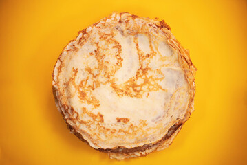 round homemade pancakes no stuffing on a plate on a bright background