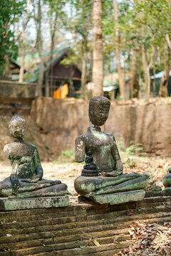 Buddha statue in front of old cave at Wat Umong Suan Puthatham, temple in Chiang Mai, Thailand. Temple of the tunnels and Buddha Dhamma garden, 