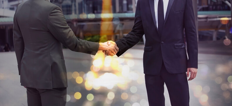 Businessman shaking hands as the trust commitment which Business Partners and factors relationship marketing for reach successful achievement and meeting commit concept