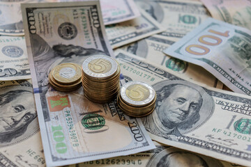 Fototapeta premium Dollar bills laid out on table. Three different columns of coins, financial crisis, money, finance, savings, salary, bank, Ukrainian money, hryvnia, eurocents, polish zloty. Photo, macro photography