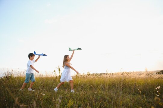 children play toy airplane. concept of happy childhood. children dream of flying and becoming a pilot.