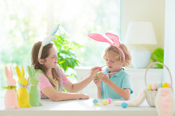 Kids on Easter egg hunt. Children dye eggs.