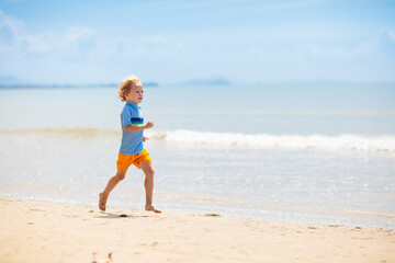 Kids playing on beach. Children play at sea.